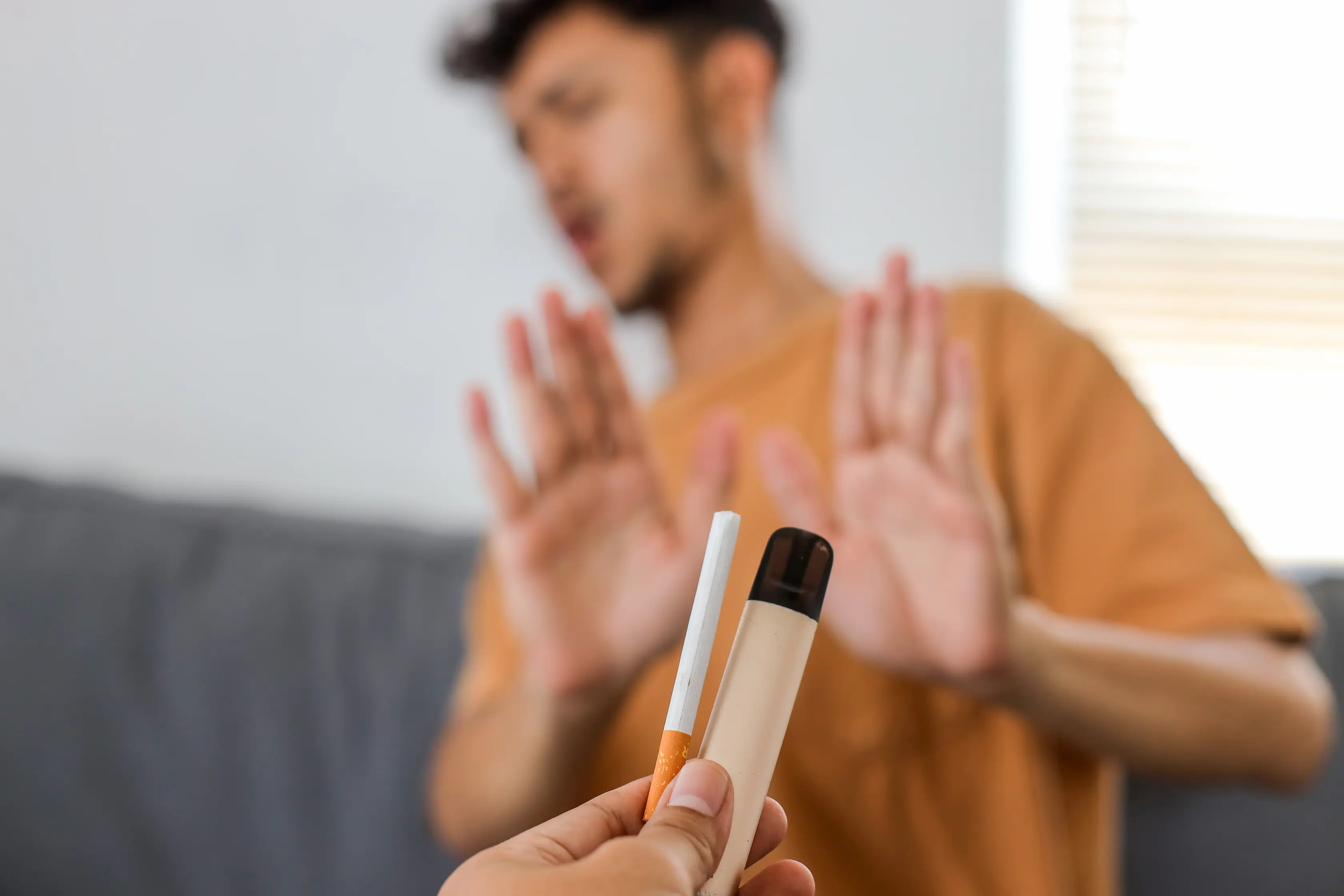Person refusing cigarette and vape being offered to them